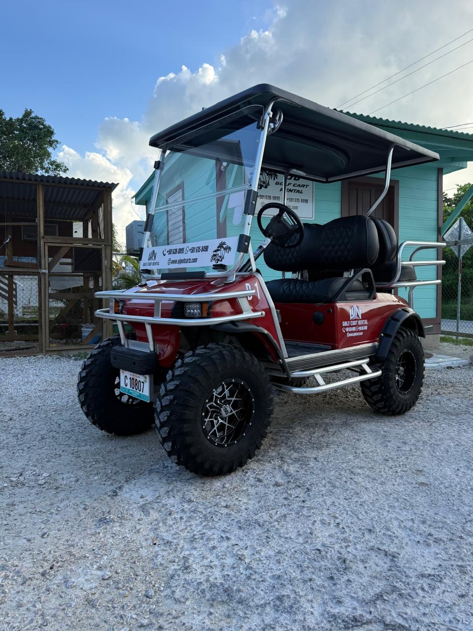 4-person golf cart rental in San Pedro Belize — red with off-road tires